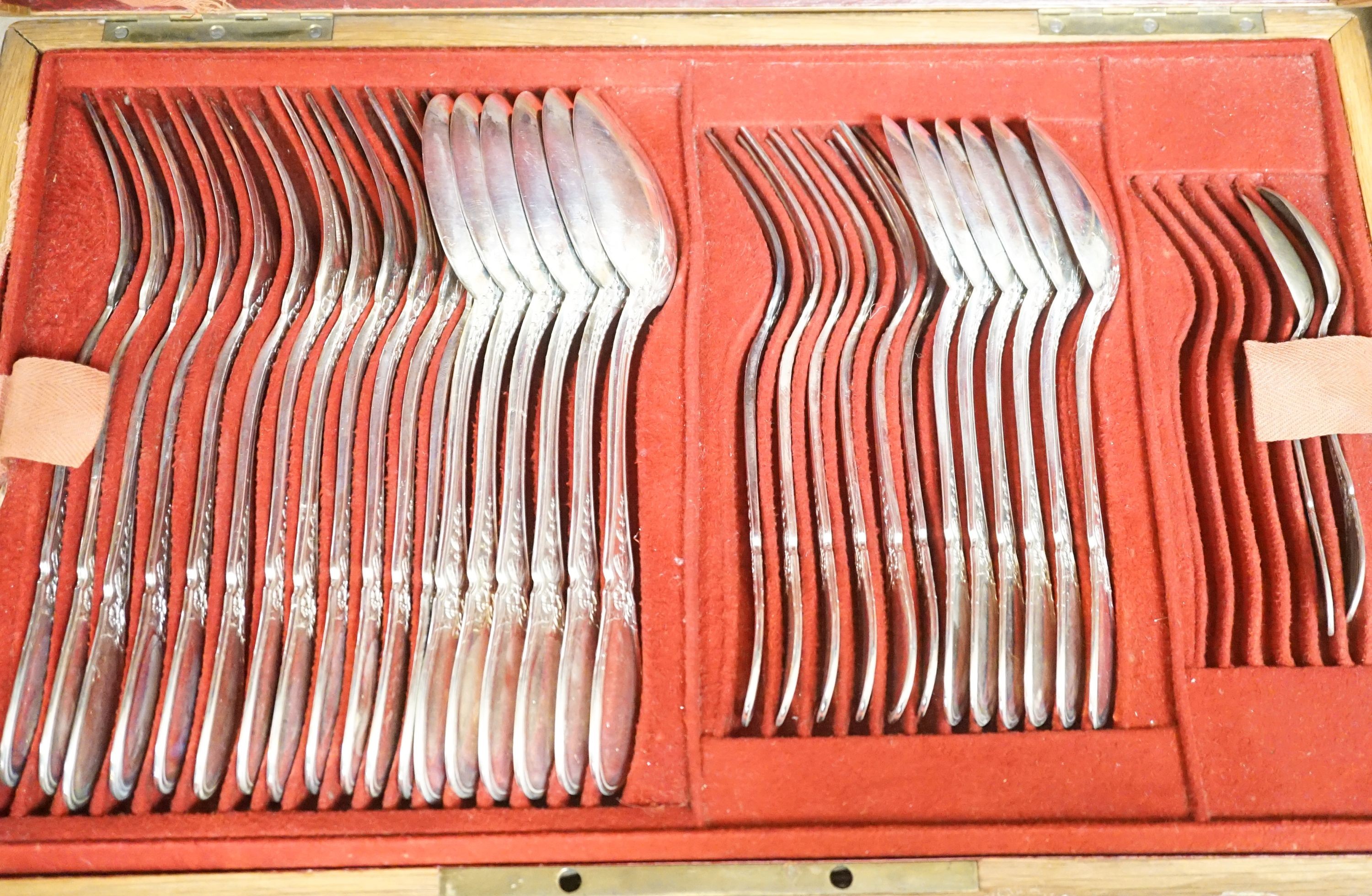 A French 950 standard white metal part canteen of cutlery, comprising fifty nine items, in oak canteen with brass handle, weighable silver 78oz.